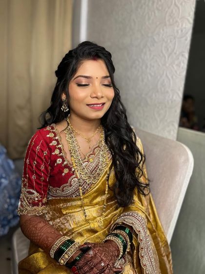A happy smile from this reception-ready bride, showing off her glowing makeup and soft, wavy hairstyle.