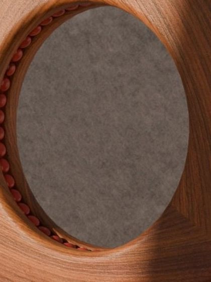 A series of images detailing the Manjadi chair, from its hand-turned legs inspired by the seed pod to the vibrant red upholstery. These shots highlight the craftsmanship and the deep cultural narrative behind this unique design.