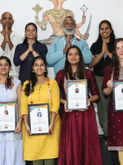 A group of newly certified Aerial Yoga teachers, celebrating their accomplishment after an intensive training program.