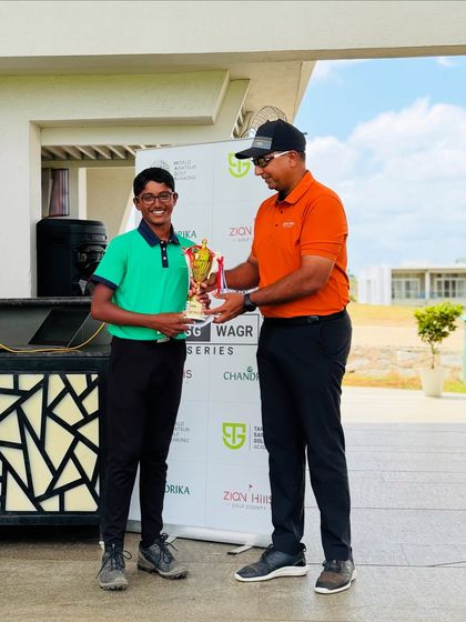 A young winner receives his trophy at the TSG WAGR Series. This series provides a platform for junior and amateur golfers to earn World Amateur Golf Ranking points.