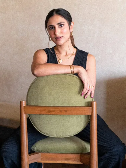A powerful, direct-to-camera pose. This image conveys strength and confidence, important qualities for Rhea's work as an empowerment coach.