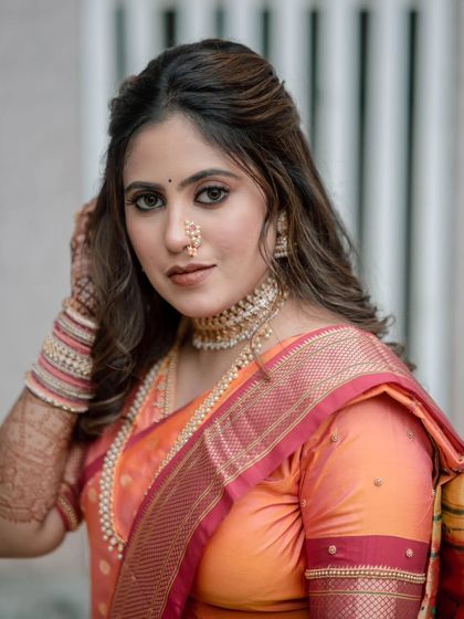 A stunning portrait of the bride. Her half up, half down hairstyle with soft waves perfectly frames her face.