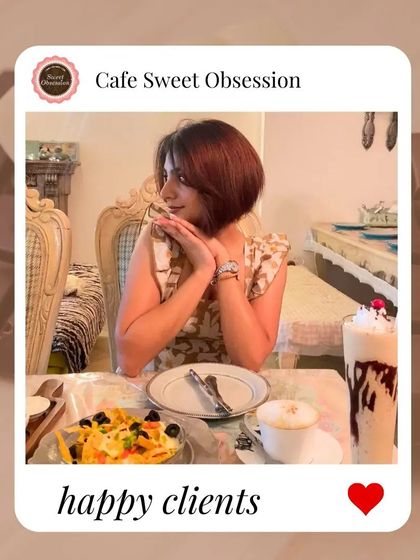 Happy clients make my day. A guest smiles, enjoying her meal and a delicious milkshake, perfectly content in our cozy cafe.