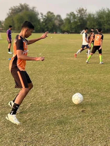 A U17 player practicing his passing technique during a training session.