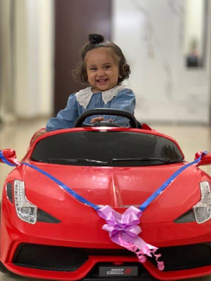 My daughter is ready to drift in her new toy car. Her happy and excited face is priceless.