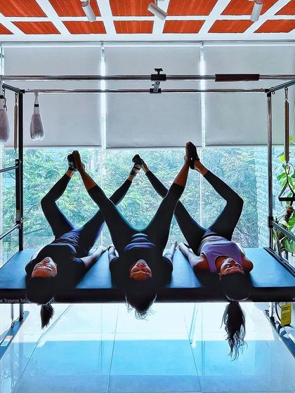 In our vibrant community, we cultivate shared wellness. This beautiful three person pose on the Cadillac is a symbol of our collective strength and support.