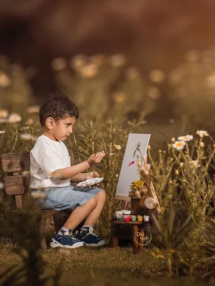 I believe in letting a child's imagination lead the way. For this outdoor session, we set up a small easel in a field of wildflowers and let this little artist paint his world. It’s a perfect example of a personality portrait that tells a unique story about your child.