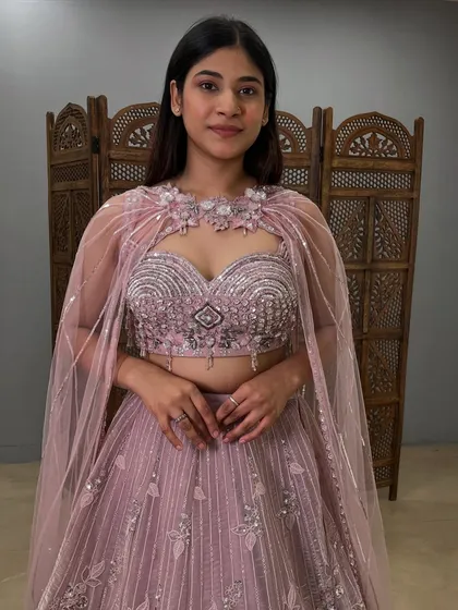 A close-up of the stunning blouse, with its detailed beadwork and elegant neckline cape.