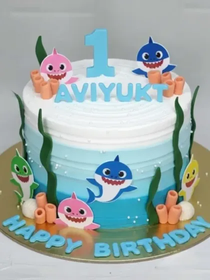 Doo doo doo doo doo doo! This Baby Shark first birthday cake is an underwater adventure. The rich eggless chocolate truffle base is covered in light whipped cream with an ombre blue effect.