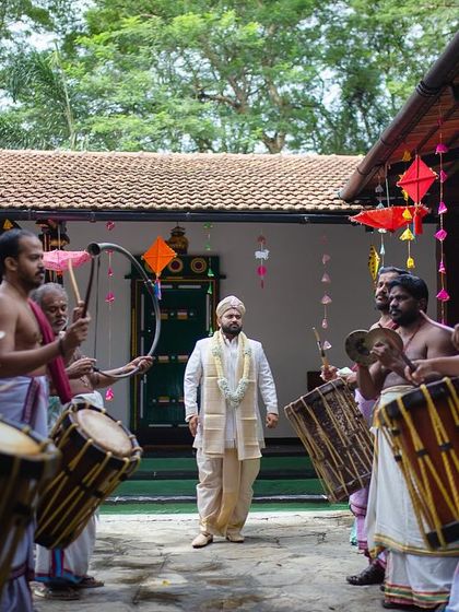 The groom's grand entrance, accompanied by Chenda Melam drummers, a powerful and traditional start to a Kerala wedding.