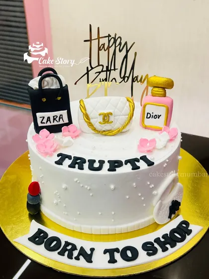 A 'Born to Shop' cake for the ultimate shopaholic. This design is topped with edible, handcrafted miniatures of shopping bags from brands like Zara and Chanel, and a Dior perfume bottle.