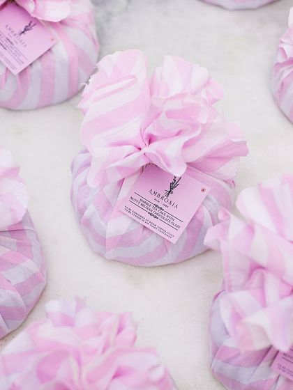 Celebrate every occasion with our delightful gourmet hampers. These pink and white fabric-wrapped cookie jars are a perfect example of our effortless bulk gifting options.