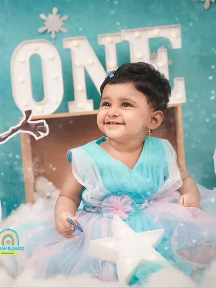 A happy, upward glance from the birthday girl, surrounded by her 'Frozen' themed decorations.
