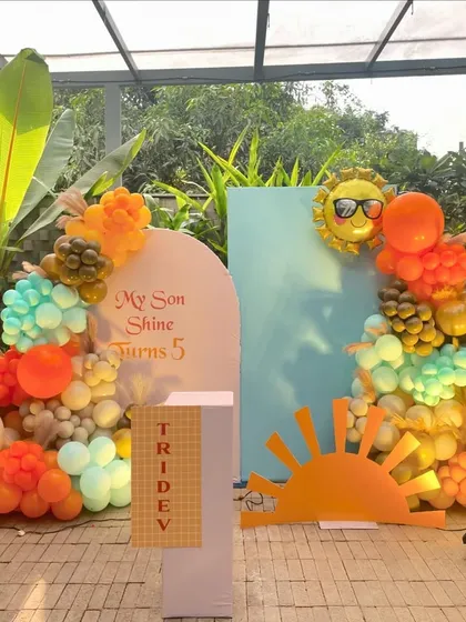 Another shot of the outdoor Sunshine theme, set against a background of green plants.