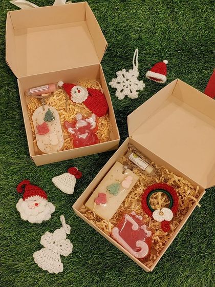 A wider view of the Christmas gift hampers, showcasing different combinations of my crochet items like Santa bookmarks, angels, and wreaths.