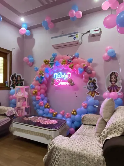 A view of the Kanha ji baby shower setup from the side, highlighting the depth and dimension of the balloon decorations.