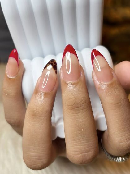 Another angle of the red French and tortoise shell accent nail, showing how the design wraps around the nail.