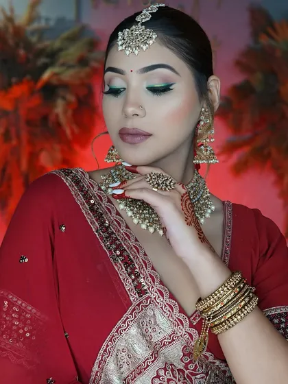 A soft, elegant pose showing the beautiful blend of the eyeshadow and the intricate details of the bridal jewelry.