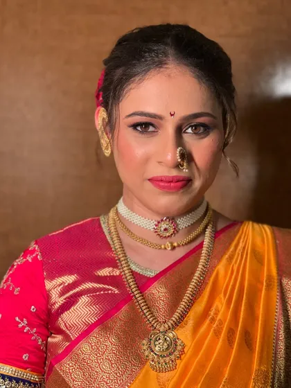 A close-up of the makeup, featuring a bold red lip and defined eyes.