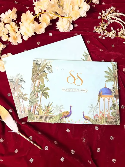 A personalized monogram is the ultimate signature touch. For this design, I created a custom 'SS' monogram in gold foil, set against a backdrop of lush gardens and peacocks, making it uniquely personal and elegant.