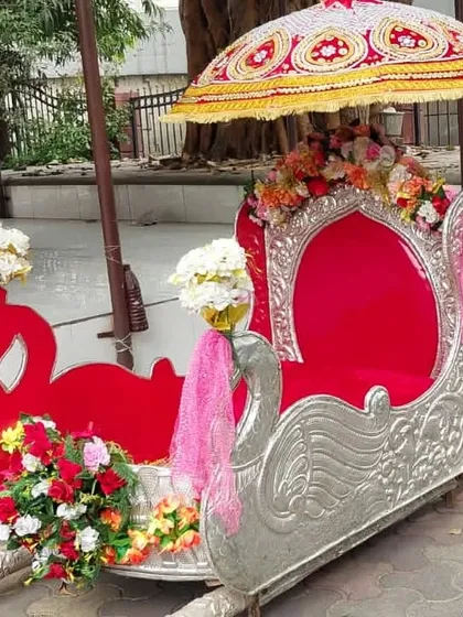 A beautiful swan-themed silver and red Palki available for rent. This open-style Doli is perfect for ensuring the bride is visible and gets amazing photos during her entrance.