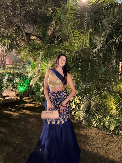 A stunning look in a royal blue and gold lehenga, perfect for a sangeet or reception.