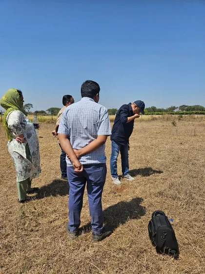 Here my team and I are analyzing the soil and energy of a new plot. This is a critical first step before any Vastu planning can begin.