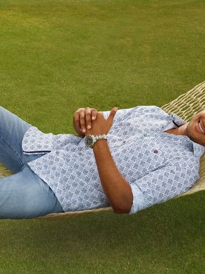 Capturing a moment of pure relaxation with Dulquer Salmaan for Otto. This light blue patterned shirt and jeans create a comfortable and stylish weekend look, perfect for the brand's casual menswear collection.