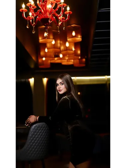 A quiet moment before the madness begins. This shot captures my personal style in a lounge setting, showing the glamorous side of my DJ persona.