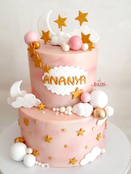 Welcoming Ananya with this dreamy two-tier cake. The "Twinkle Twinkle Little Star" theme with soft pink marble, clouds, moons, and stars creates a magical and sweet centerpiece for a baby celebration.