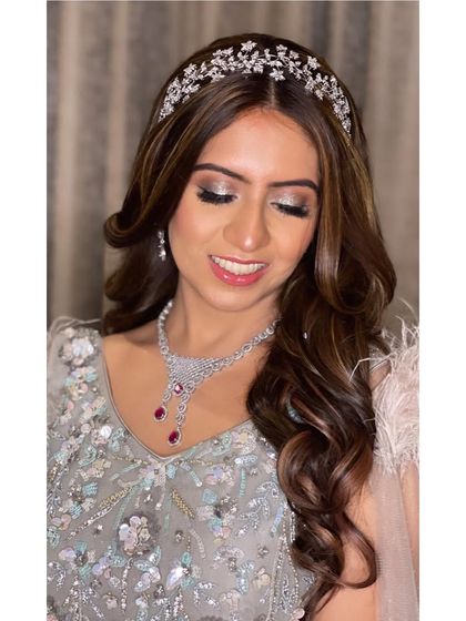 A glamorous engagement look featuring a sparkling headband and long, flowing waves. This hairstyle is perfect for the bride who wants to feel like a princess on her special day.