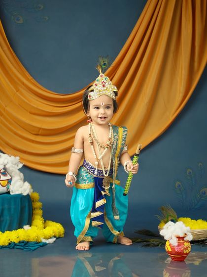 Tiny feet and divine mischief. This little Krishna stands tall and proud in his festive outfit, ready to celebrate Janmashtami.