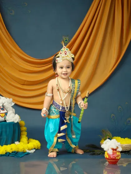 Tiny feet and divine mischief. This little Krishna stands tall and proud in his festive outfit, ready to celebrate Janmashtami.