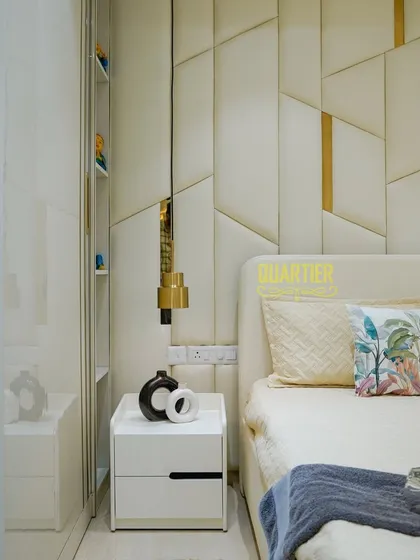 This angle showcases the custom bedside table and wardrobe with reflective surfaces in the Tata LaVida master bedroom. The seamless design and high-quality finishes contribute to the room's overall feeling of modern luxury.