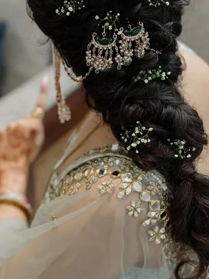 The art of bridal hairstyling. I worked with the hair artist to design this beautiful braided look, incorporating delicate baby's breath and a traditional passa to complement the bride's mirror-work blouse.