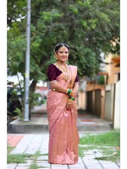 A full-length shot showcasing the elegant drape of the saree and the complete traditional look for the Gouri Pooja.