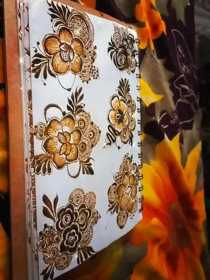 More practice with different flower bunches. Learning to draw various types of flowers, from roses to hibiscus, makes your henna art much more dynamic and interesting.