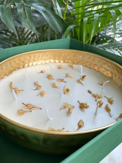 A large jasmine-scented Urli candle in a gold hammered bowl, a truly elegant and non-toxic gift.