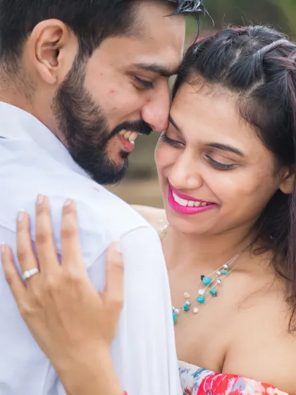A beautiful close-up capturing a smile and a loving embrace. This shot highlights the genuine emotion and happiness shared between the couple.