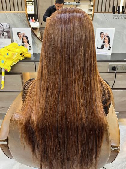 The "after" shot, showing a beautiful, warm copper-brown global color that completely transformed her look.