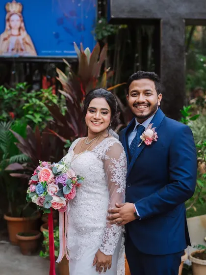 A lovely outdoor portrait of the newly married couple. The bride's elegant gown and the groom's sharp suit look perfect together.