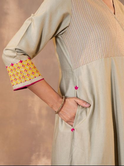 Functionality is key in our designs. This detail shot shows the practical side pocket and the beautiful Pakka embroidery on the sleeve cuff of our Ruhani Sage Green Kurta, blending utility with artisanal beauty.