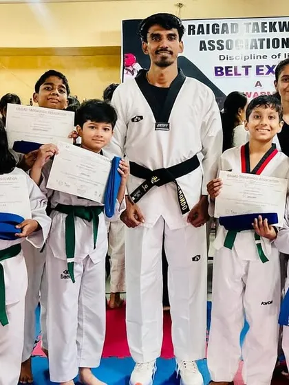 A group of my students proudly holding their certificates and awards after a belt exam.