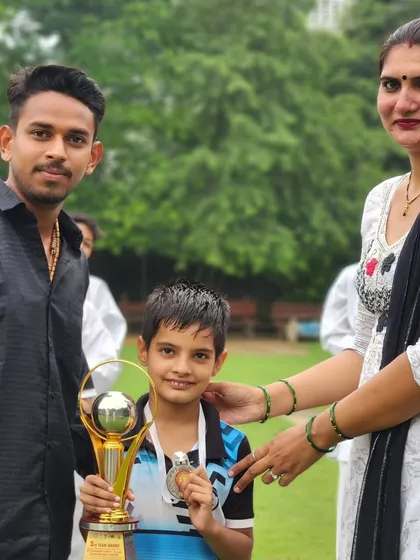 Celebrating a student's victory at the District Karate Championship with his family. Their support is crucial.