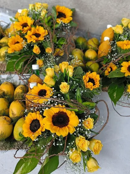 Celebrating the season of mangoes with these vibrant gift baskets. Each basket is overflowing with fresh mangoes and adorned with bright sunflowers, creating a cheerful and delicious gift.