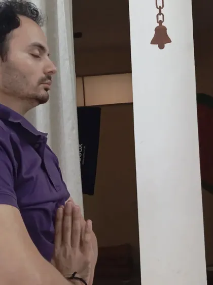 A seeker stands in prayer, absorbed in the moment. The space invites both silent meditation and expressive devotion.