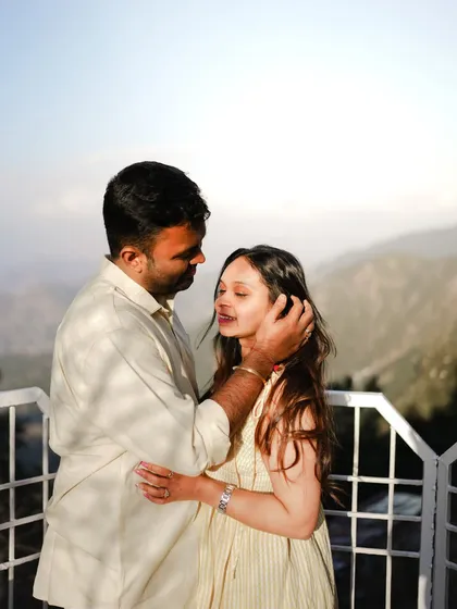 An intimate and tender moment on a balcony overlooking the hills of Dalhousie.