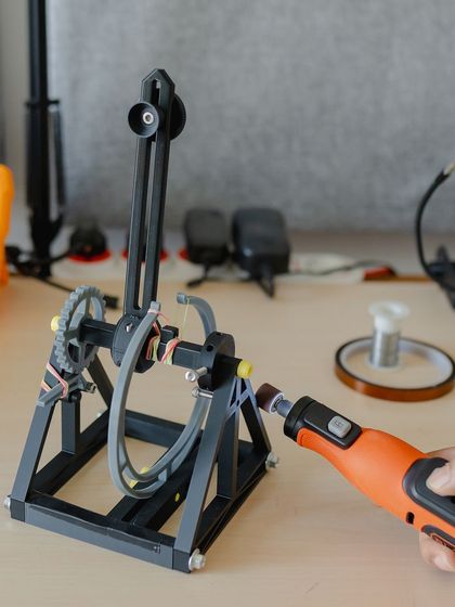 Here, we're using a rotary tool to fine-tune a part for the catapult, showing how real tool skills can be integrated into the build.