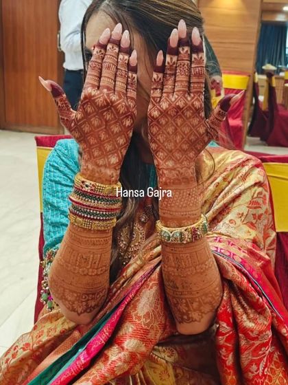 A stunning example of a deep, rich mehendi stain. The dark color makes the intricate jaali work and traditional patterns on the back of the hands stand out beautifully.