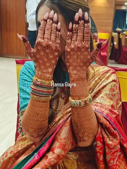 A stunning example of a deep, rich mehendi stain. The dark color makes the intricate jaali work and traditional patterns on the back of the hands stand out beautifully.